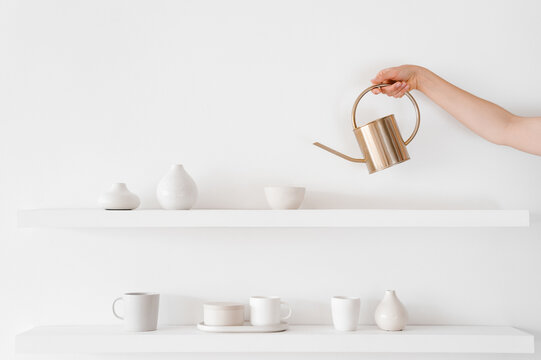 Crop person pouring water in bowl