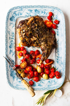 Roast Lamb with vine tomatoes and garlic