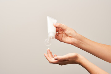 Crop female with moisturizing cream