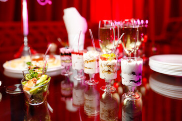 buffet table with toasts and snacks and desserts in red tones