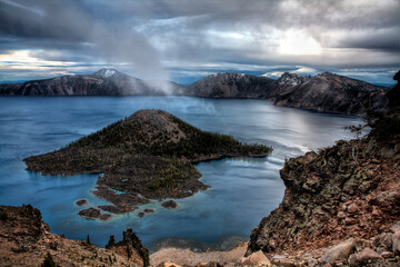 USA, Oregon, Crater Lake National Park. Mist rises over Wizard Island.