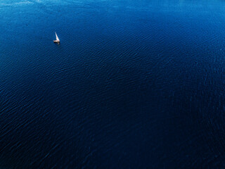 Tiny sailboat in the sea