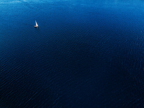 Tiny Sailboat In The Sea