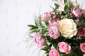 Beautiful bouquet with roses on white background, closeup. Space for text