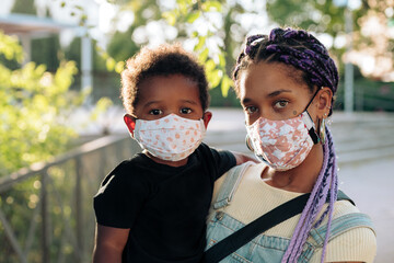Multiracial mother and child with face masks