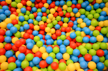 Children's party, a games room, a box filled with small colored balls.many small colorful plastic balls in the pool