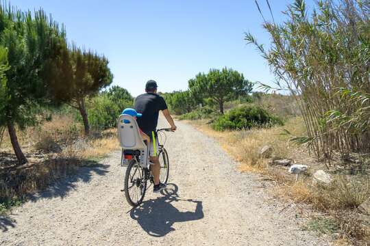 Father with his son riding a bicycle outdoors