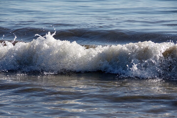 Full frame close-up view of a Pacific ocean wave hitting the beach in California