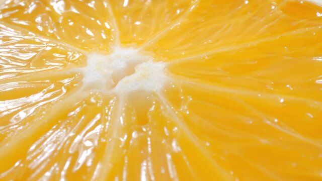 Macro Dolly shot of fresh juicy orange fruit slices. Close-up fruit texture.