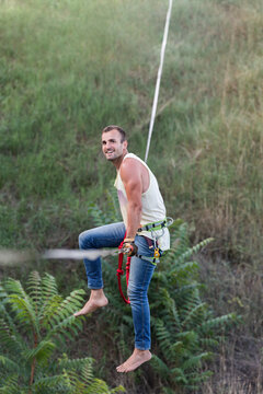 Happy man highline slacklining