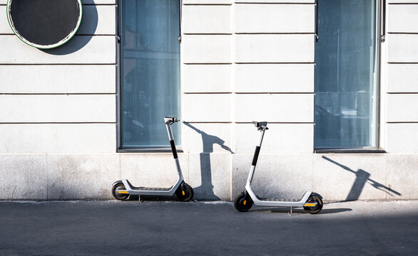 Electric urban scooter parked in the street in the city