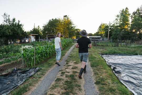 Farmer couple laughing and walking together in the evening.