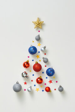 Christmas composition. Christmas tree made of colorful decorations on white background. Flat lay, top view, square