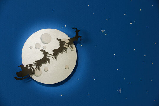 Merry christmas and happy new year greeting card with copy-space. Winter christmas night landscape.Santa and his sleigh flying over snowy landscape