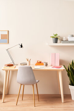Chair and table against beige wall