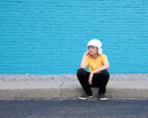 Young Boy Wearing Helmet Thinking with Copyspace