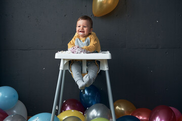 Baby boy enjoy first birthday celebration cake.