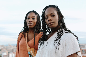Two black attractive young women looking at camera