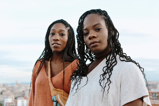 Two Black Attractive Young Women Looking At Camera