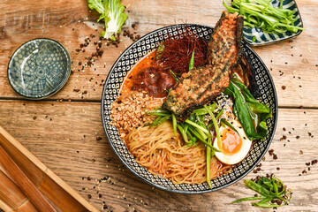 Miso Ramen Asian noodles with egg, pork and pak choi cabbage in bowl on white background. Japanese cuisine. Top view. Banner