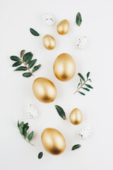 Close-up top view of golden Easter eggs on white background, Happy Easter minimal concept