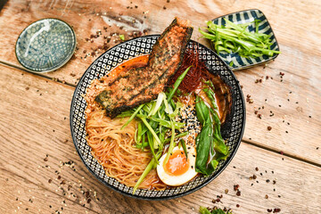 Miso Ramen Asian noodles with egg, pork and pak choi cabbage in bowl on white background. Japanese cuisine. Top view. Banner