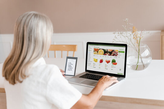 Woman making online order of fruits on laptop
