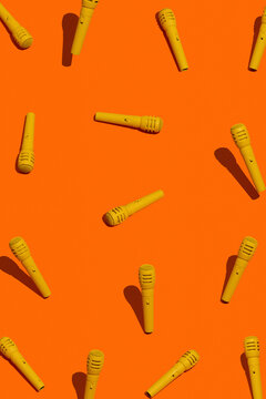 Yellow microphones on orange background