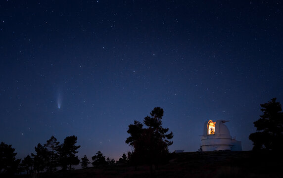 Observatory building against starry sky and comet Neowise
