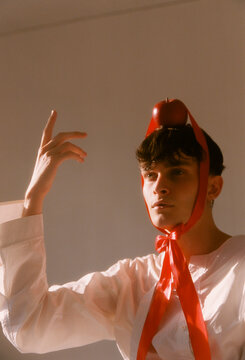man with red apple headdress.