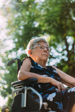 Elderly woman sitting outdoor at sunset