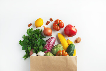 Healthy food background. Healthy vegan vegetarian food in paper bag vegetables and fruits on white, copy space. Shopping food supermarket and clean vegan eating concept
