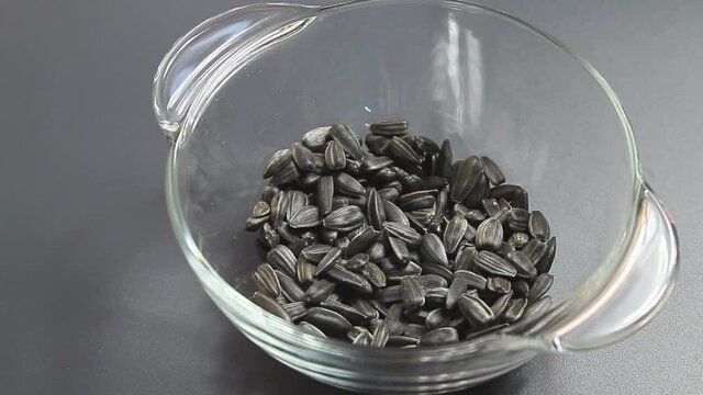 Sunflower seeds falling into a bowl
