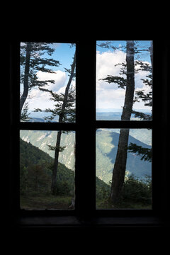 Fototapeta Closed window overlooking mountains