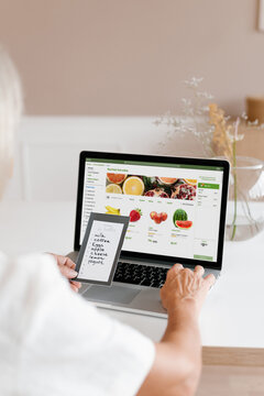 Woman making online order of fruits on laptop