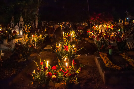 Marigolds and Festive Candles Decorate an Old Graveyard