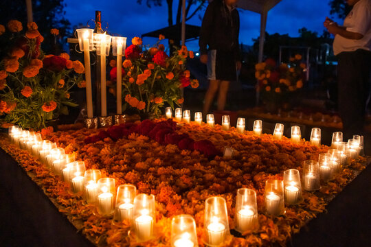 Marigolds and Candles Adorn a Community Graveyard at Night