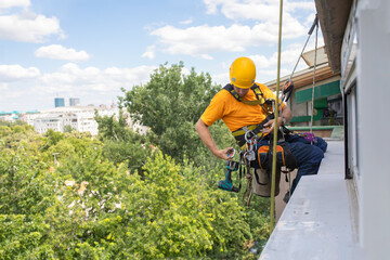Working at elevations. Rope access, high-altitude outdoor work.