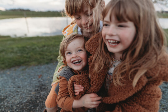 Three Young Kids Cuddling