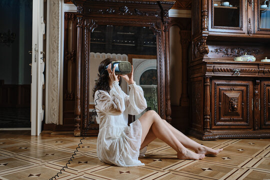 A girl in a vr helmet in old classic interior