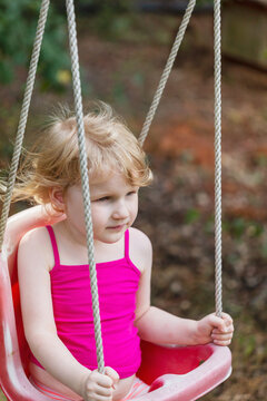 Toddler relaxing in swing
