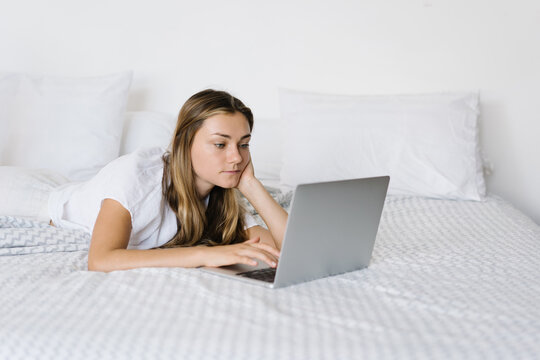 Serene woman browsing netbook at home