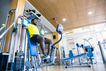 Man in yellow T-shirt on exercise machine