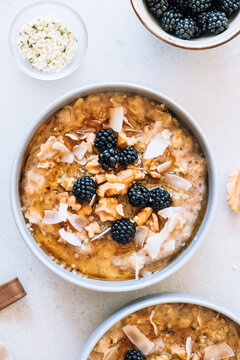 Homemade porridge topped with wild blackberries, walnuts and shr
