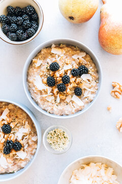 Homemade porridge topped with wild blackberries, walnuts and shr