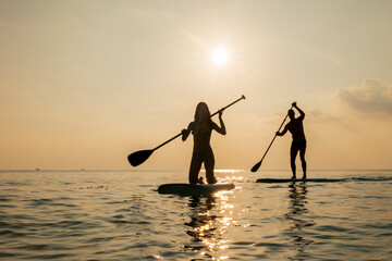 a couple paddle boarding in the Maldives