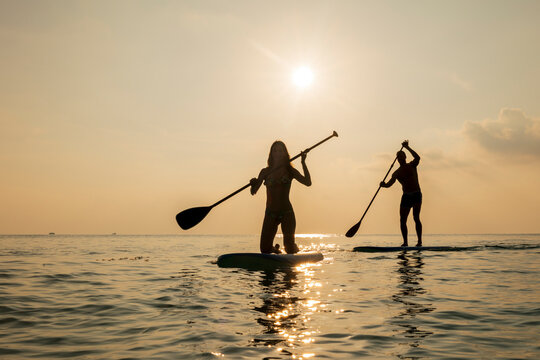 a couple paddle boarding in the Maldives