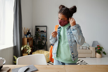 Schoolgirl Putting Mask On Face