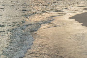 sea waves reaching the shore at sunset..