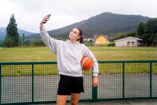 Woman Taking A Selfie With Basketball Clothes.